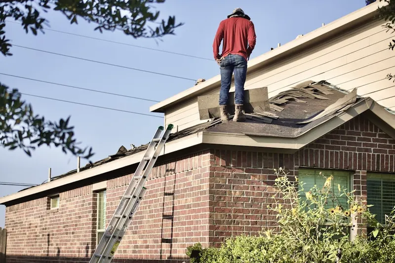 Professional roofer working on a residential roof in North Fort Lewis